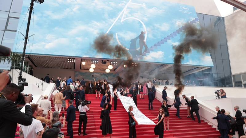 Members of the feminist movement "Les Colleuses" hold a banner, displaying the names of 129 women who died as a result of domestic violence ahead of the screening of Holy Spider at the Cannes film festival in Cannes, France. (Photo by John Phillips/Getty)