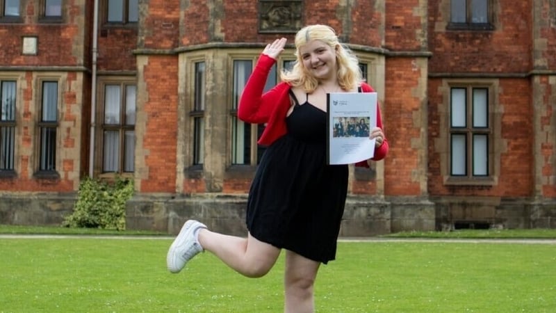 Réiltín holding her Derry Girls dissertation