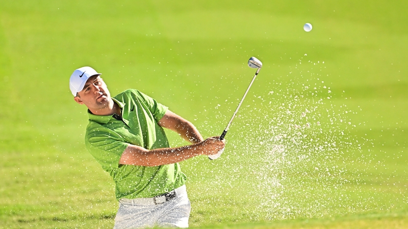 Scottie Scheffler hits a shot from the bunker on the 12th hole