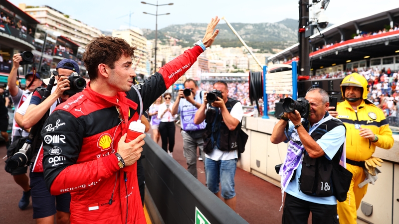 Charles Leclerc waves to the crowd after securing pole position on his home circuit