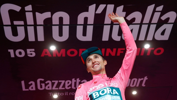 Jai Hindley celebrates on the podium after the 20th and penultimate stage