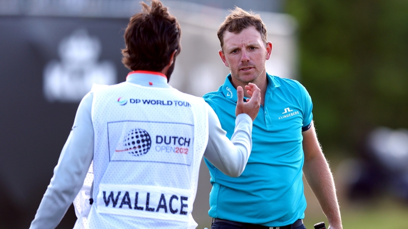 Matt Wallace thanks his caddie, Sam Bernard after playing his putt on the 18th hole