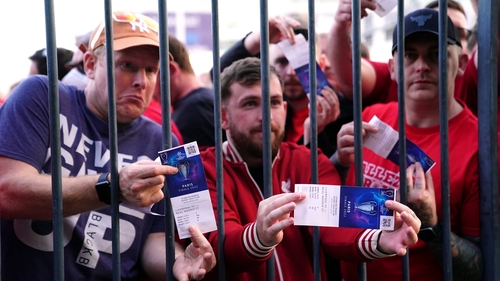 Liverpool fans stuck outside the ground show their match tickets during the UEFA Champions League Final