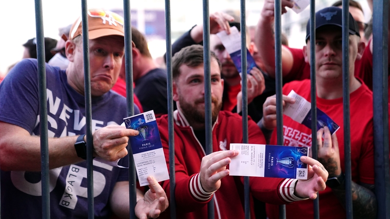 Liverpool fans stuck outside the ground show their match tickets during the UEFA Champions League Final
