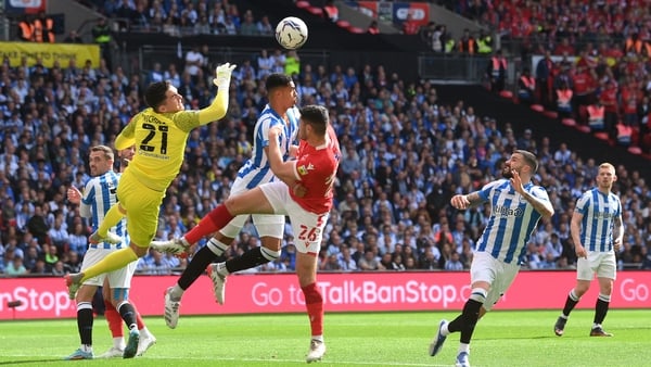 Scott McKenna of Nottingham Forest is challenged by Levi Colwill of Huddersfield