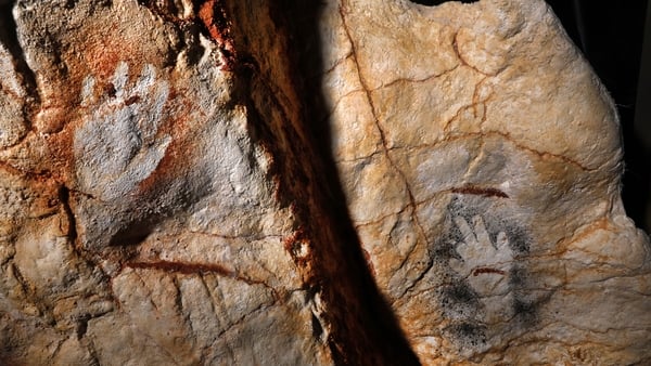 Replica paintings of the 69 red or black hand prints, including by children
