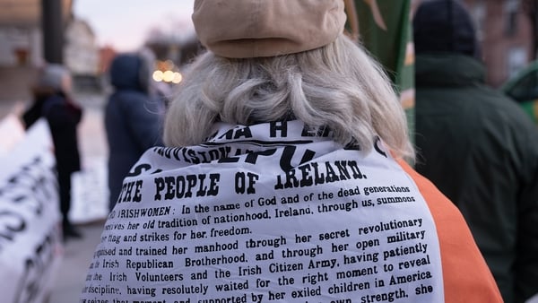 Conor Horgan: Flag No. 28 / A protestor wears an Irish flag with the Proclamation printed on it during an anti-lockdown protest outside the Department of Health, Baggot Street, Dublin
