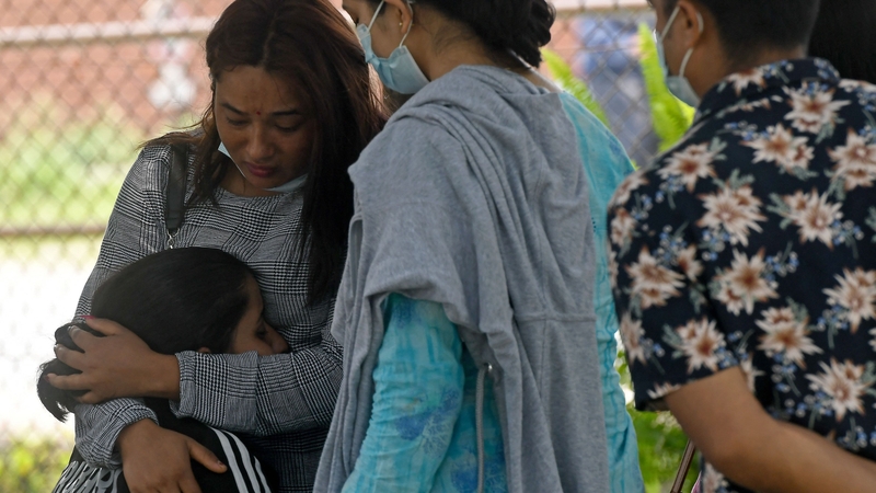 Family and relatives of passengers on board the Twin Otter aircraft operated by Nepali carrier Tara Air, weep outside the airport a day after it crashed, in Pokhara