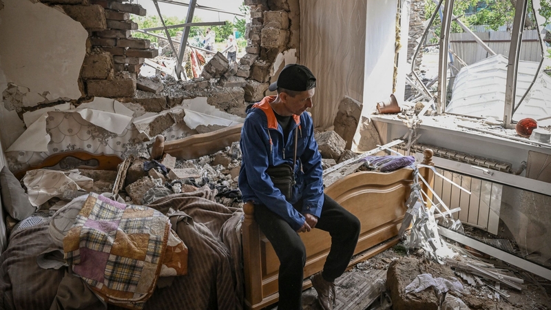 Sergiy Tarasyuk, 49, sits on his bed in his destroyed house after a missile strike at Slovyansk in the Donbas region of Ukraine