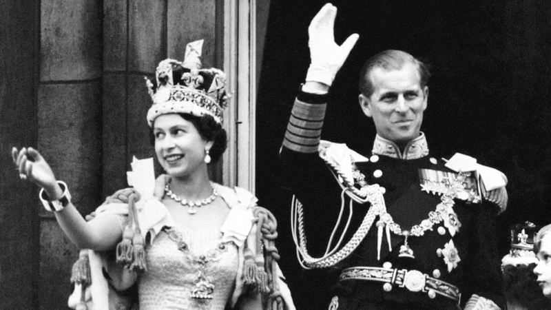 Queen Elizabeth II and the Duke of Edinburgh wave from the balcony of Buckingham Palace after the coronation on 2 June 1953