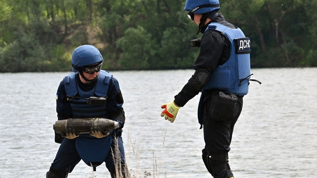 Ukrainian de-miners collect unexploded material in Horenka village, Kyiv region on 27 May