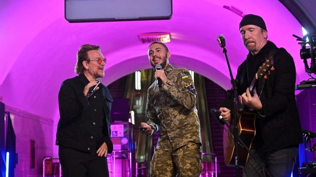 Bono, Antytila (C), a Ukrainian band leader and now army serviceman, and The Edge
perform at subway station, now bomb shelter, in Kyiv on 8 May