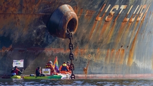 Greenpeace activists stage an action against the ship Ust Luga, before it was due to unload Russian oil in the harbour of Aasgaardstrand, Norway, on 25 April