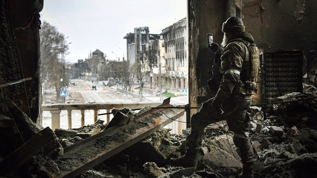 A Russian soldier patrols at the Mariupol drama theatre 12 April