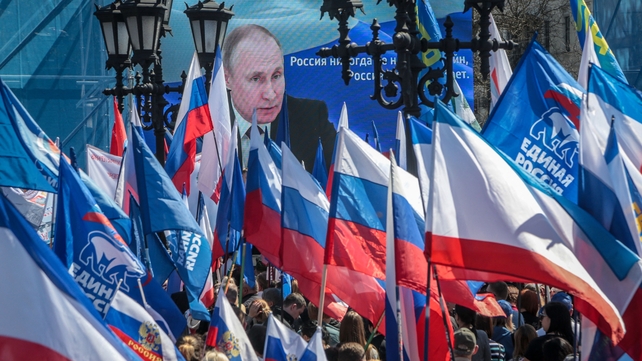 People wave flags during a rally in support of the Russian invasion in Ukraine, in Simferopol, Crimea on 7 April