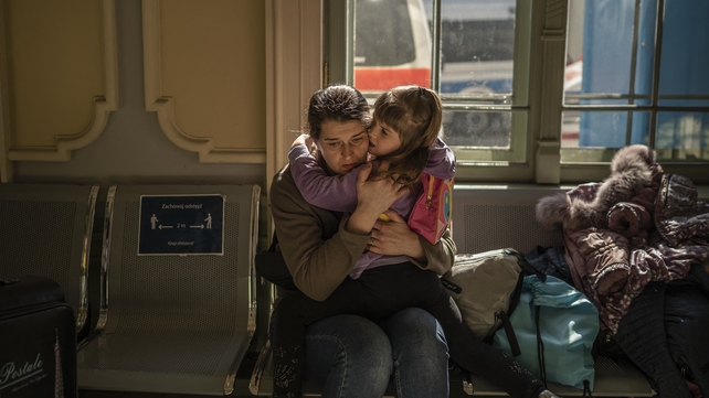 A Ukrainian evacuee hugs a child in the train station in Przemysl,
near the Polish-Ukrainian border, on 22 March