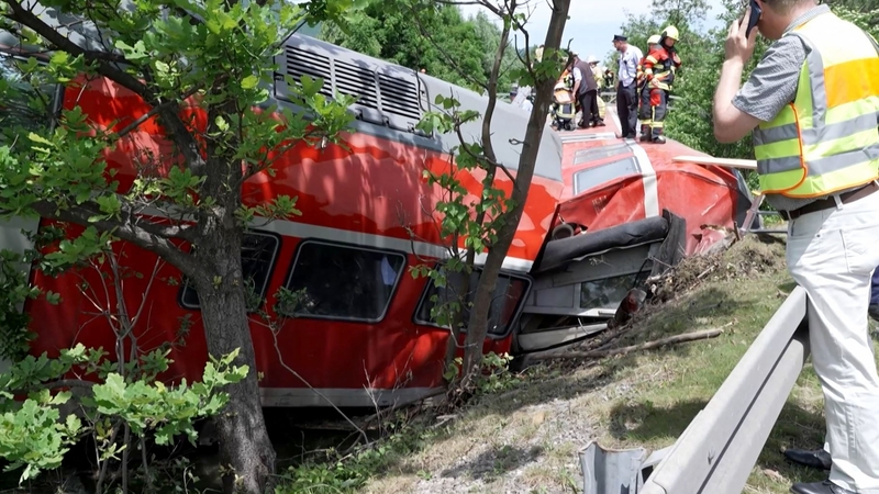 Firemen work around a derailed trail in Burgrain in southern Germany