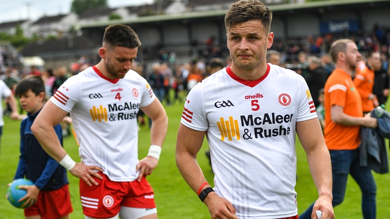 Padraig Hampsey, left, and Michael McKernan react to the defeat to Armagh