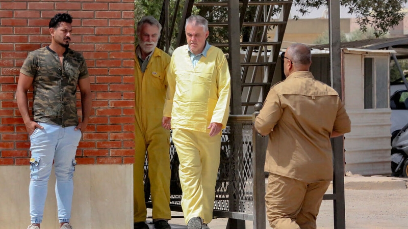 James Fitton (L) and Volker Waldmann arrive at a courthouse in Baghdad