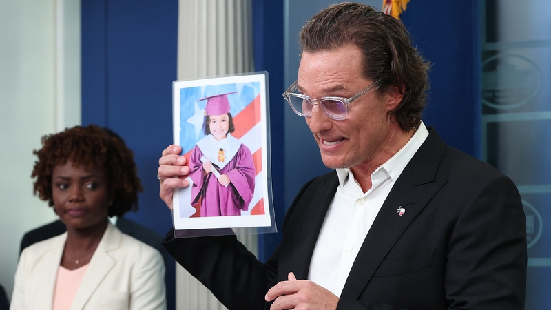 After meeting US President Joe Biden, actor Matthew McConaughey holds up a photograph of one of the victims of the school shooting in Uvalde, Texas