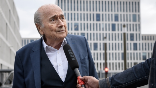 Sepp Blatter speaks to a journalist as he arrives at the Federal Criminal Court