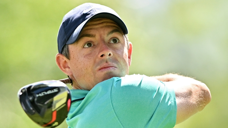 McIlroy watches his tee shot on the 11th hole