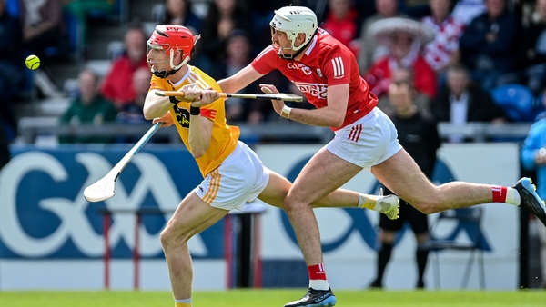 James McNaughton of Antrim gets a shot away despite the attention of Tim O'Mahony
