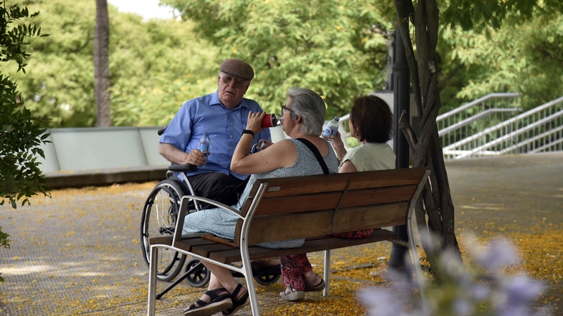 Elderly people seek shelter and stay hydrated during the heatwave in Seville