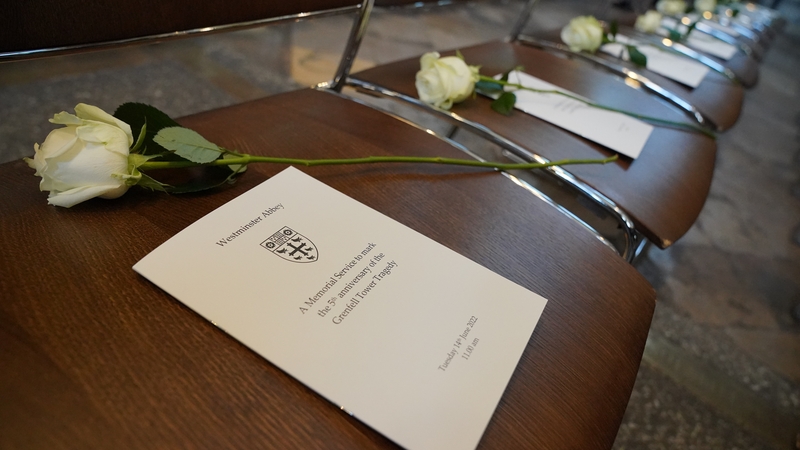 The order of service and a white rose placed on chairs at Westminster Abbey