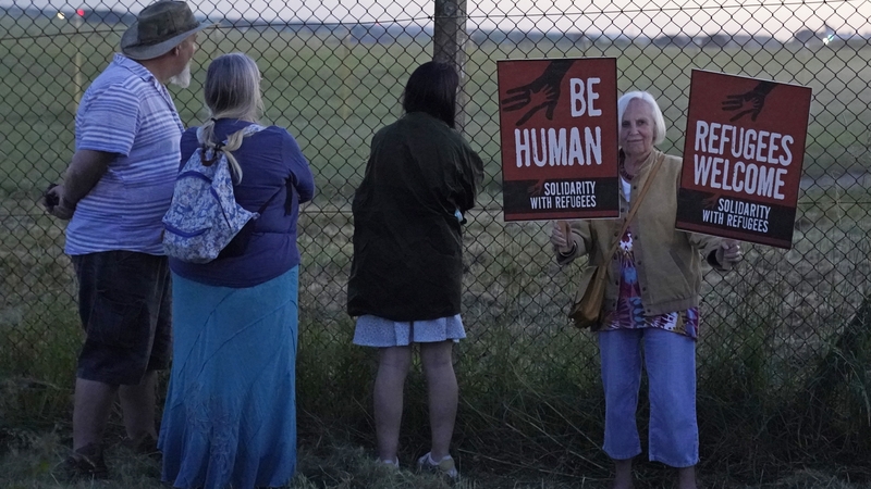 Protesters gather at the perimeter of MoD Boscombe Down, near Salisbury, where a Boeing 767 aircraft was believed to be the plane set to take asylum seekers from the UK to Rwanda