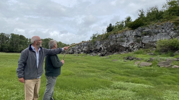 Archaeologist Michael Gibbons showing Muintearas CEO Seán Ó Coistealbha the discovery