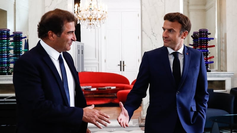 French President Emmanuel Macron shakes hands with Les Republicains party President Christian Jacob (L)