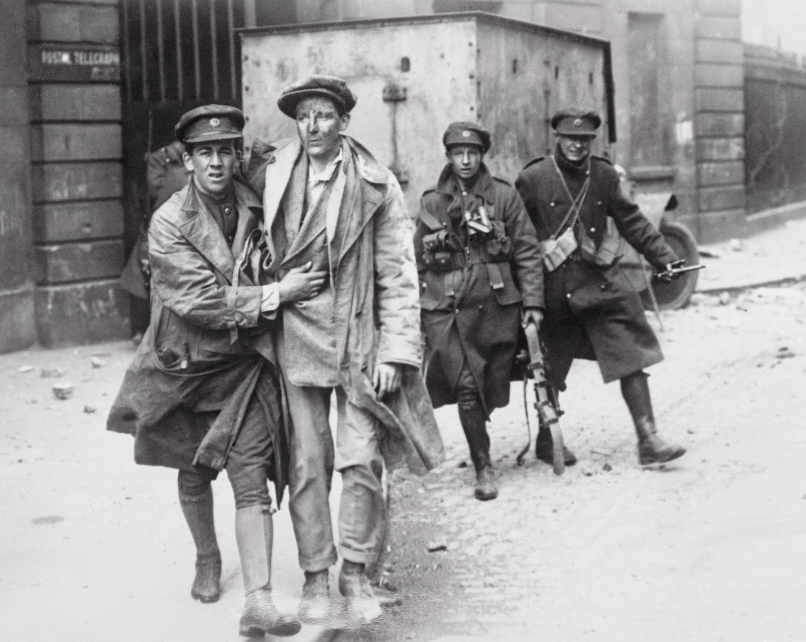 One of the wounded rebels being brought out of the smoking and burning Four Courts building after the surrender to the National Army troops. Photo: Getty Images