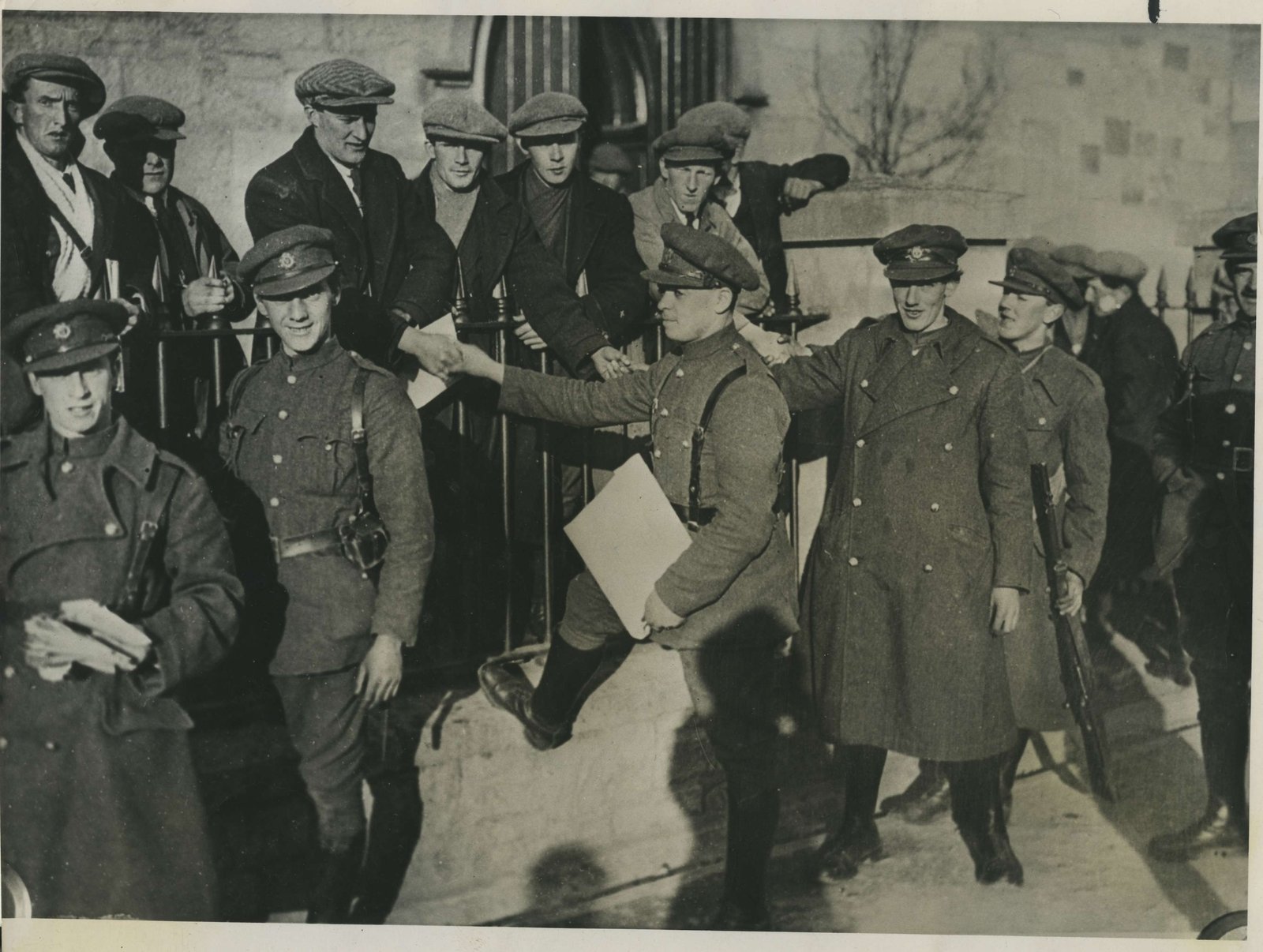 A posed 'reconciliation' after the Kilkenny clashes. Cheesy grins from the soldiers, suspicious scowls from the IRA men (Credit: Kilmainham Gaol Archive)
