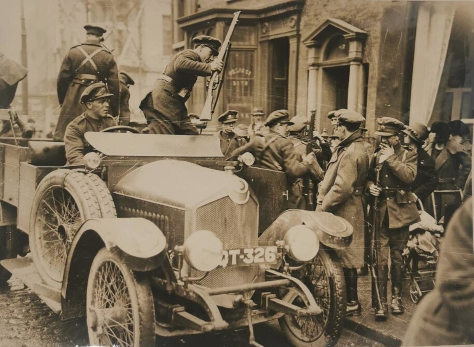 ARREST: Dumbfounded civilians look on as Free State troops swarm Harry Ferguson's Garage to arrest Leo Henderson. (Credit: By permission of Conway's Yard, Oliver Plunkett Street, Cork.)