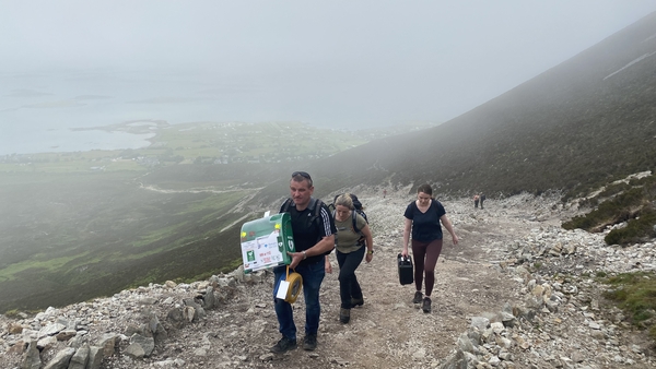 Community first responders Darren Forde, Odette Duignan and Eimear Morrin climbing the reek with defibrillator equipment