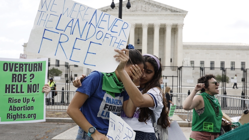 Abortion-rights activists Carrie McDonald and Soraya Bata react to the ruling outside the US Supreme Court today