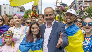 Taoiseach Micheál Martin with Ukrainian refugee Veronika Mirtalibova taking part in the Dublin Pride
