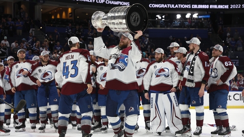 The Colorado Avalanche celebrate with the iconic trophy