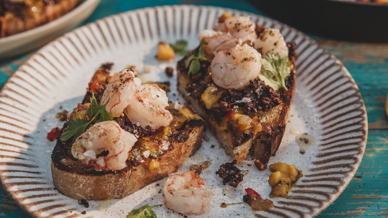 Plump prawns and crumbly black pudding bring out the best in each other in this simple and flavourful dish.