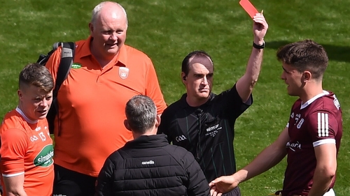 David Coldrick shows a red card to Aidan Nugent (Armagh) and Sean Kelly (Galway)