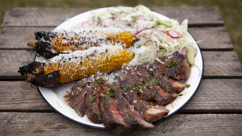 A perfectly grilled steak with buttery Parmesan corn and an aromatic fennel salad.