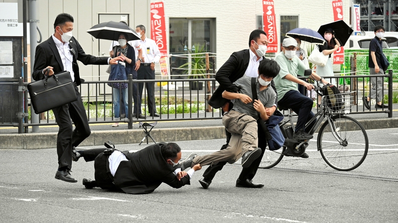 Security forces tackle the suspected gunman in Shinzo Abe's assassination