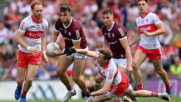 Galway midfielder Paul Conroy is tackled by Derry's Brendan Rogers