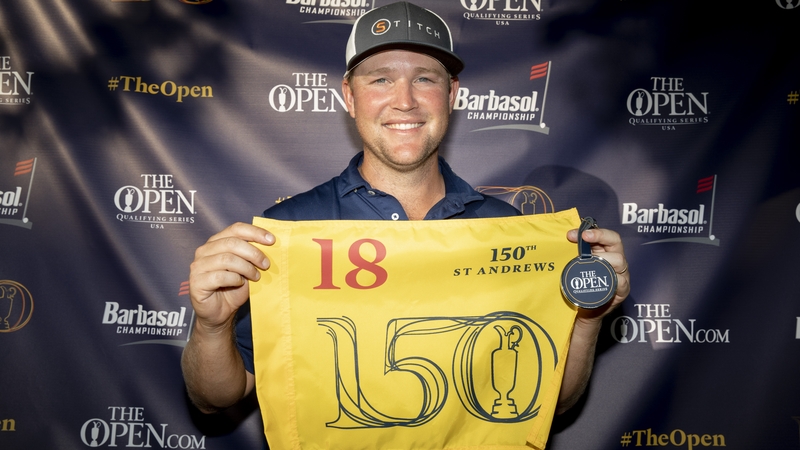 Trey Mullinax holds a flag after qualifying for the 150th Open Championship
