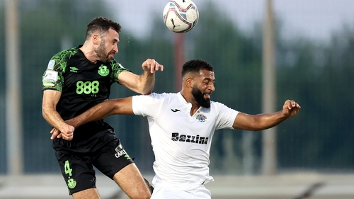 Roberto Lopes (L) rises above Tereence Groothuse at Centenary Stadium in Ta' Qali, Malta