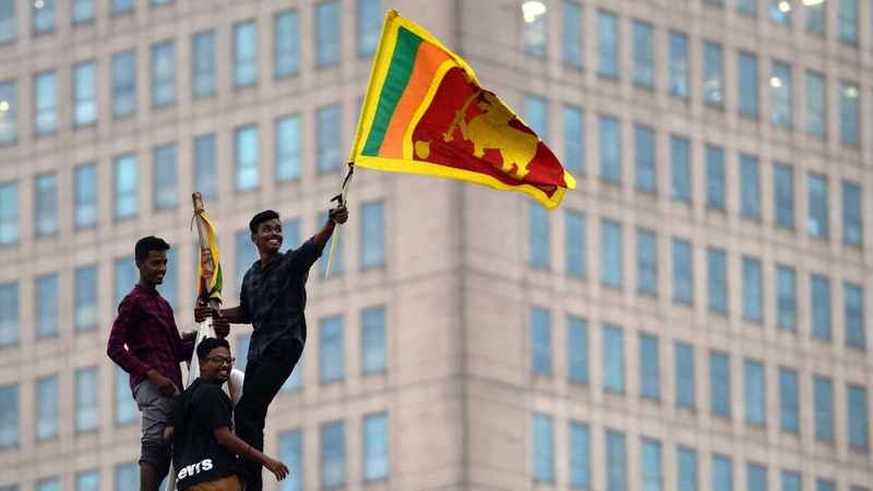 A man waves Sri Lanka's national flag in the capital Colombo