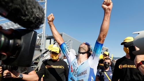 Michael Matthews raises his arms aloft after winning the 14th stage
