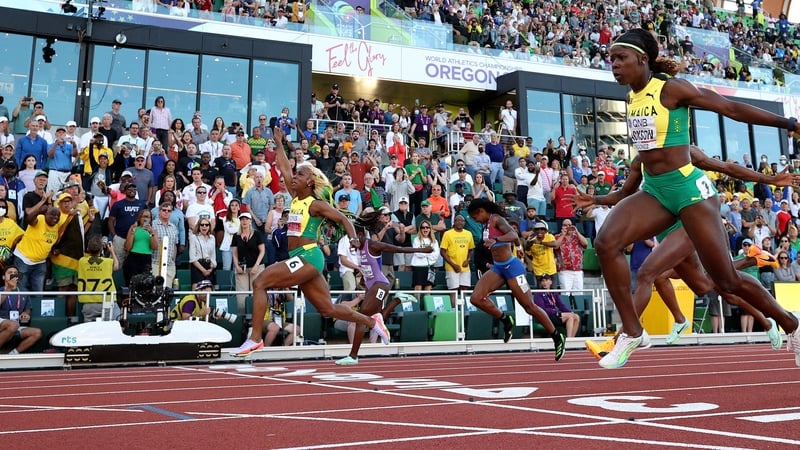 Shelly-Ann Fraser-Pryce raises her arm aloft after leading home a Jamaican clean sweep in the 100m final