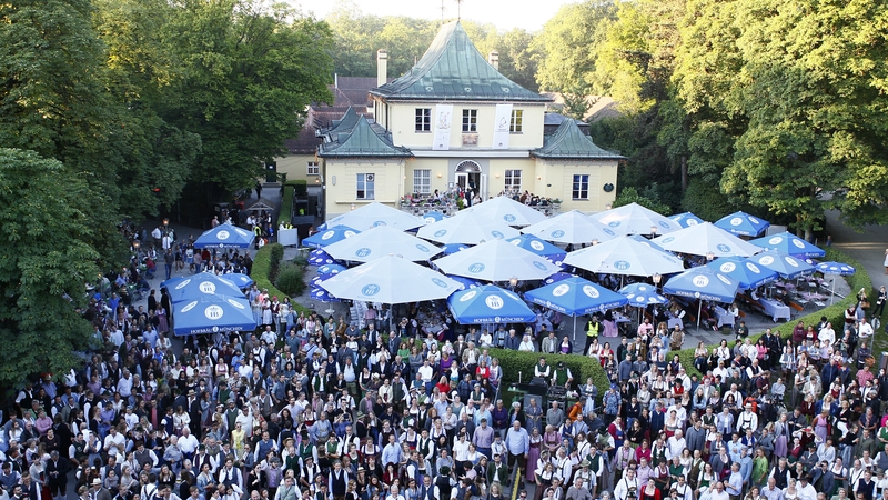 Guests enjoy the Kocherlball at the Chinese Tower in the English Garden in Munich at the weekend